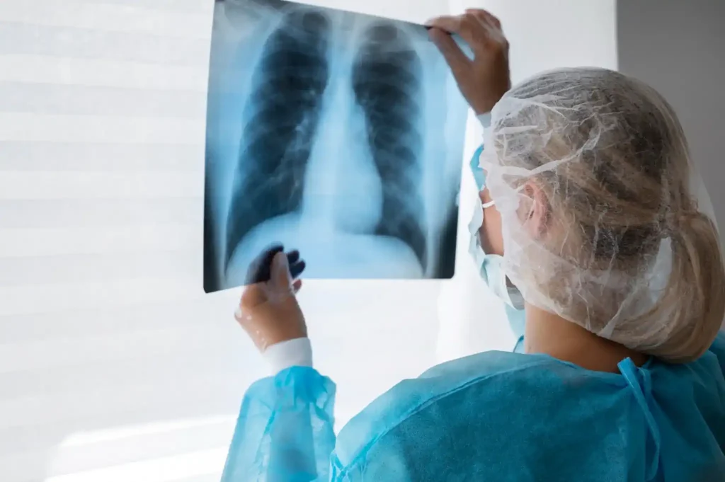 Profissional da área de radiologia analisando radiografia de tórax em ambiente clínico